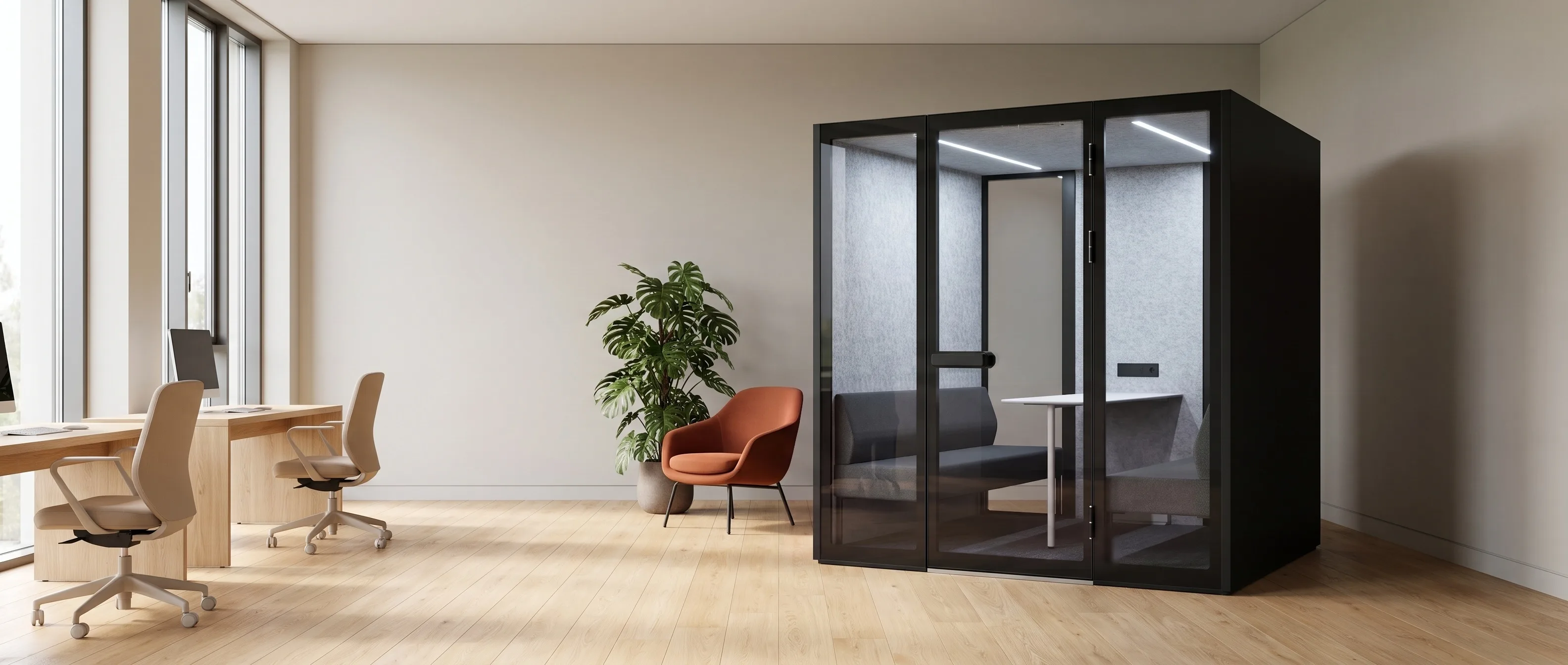 XL-Pod conference pod in a warm open-plan office, grey sofas and a meeting table visible through the glazed doors