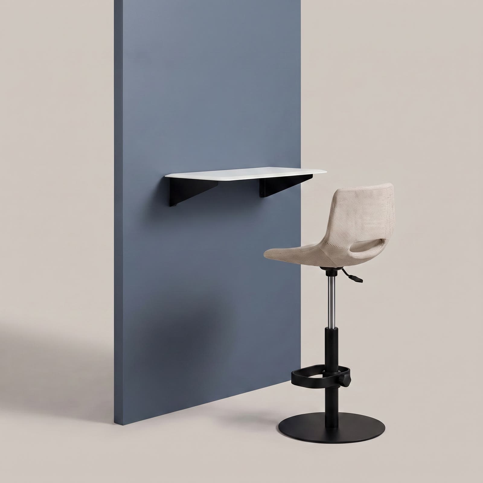 The furniture included with an S-Pod — a height-adjustable sit-stand desk and a matching height-adjustable stool, shown against a slate blue-grey panel