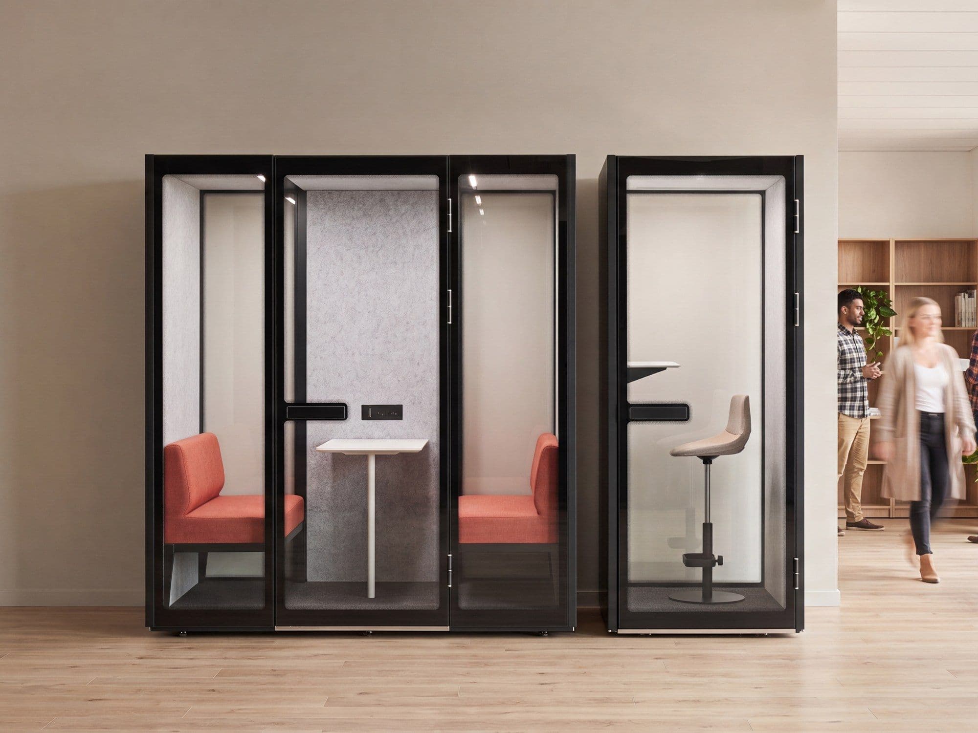 Two Peacepods side by side in a bright open-plan office with a timber floor