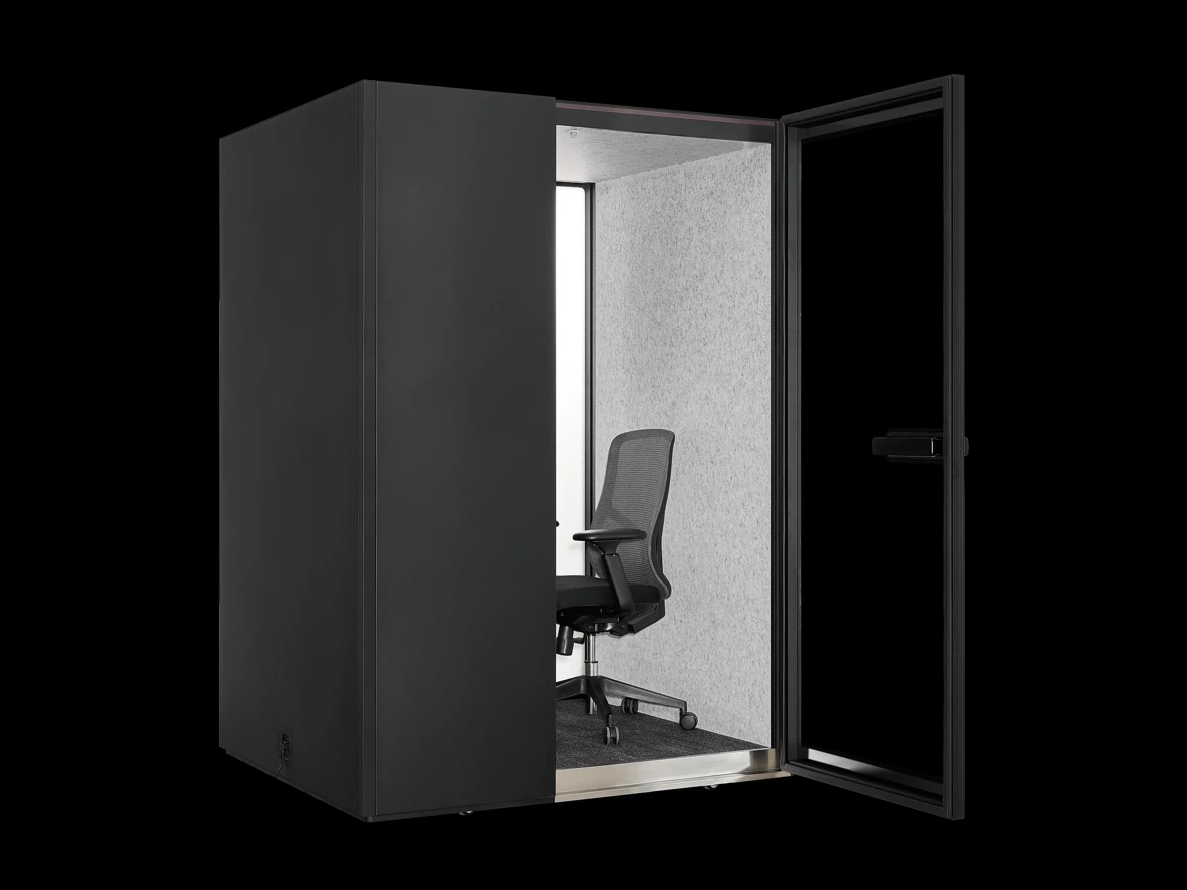 An MW-Pod with its door open, showing the wall-mounted desk and black mesh office chair inside