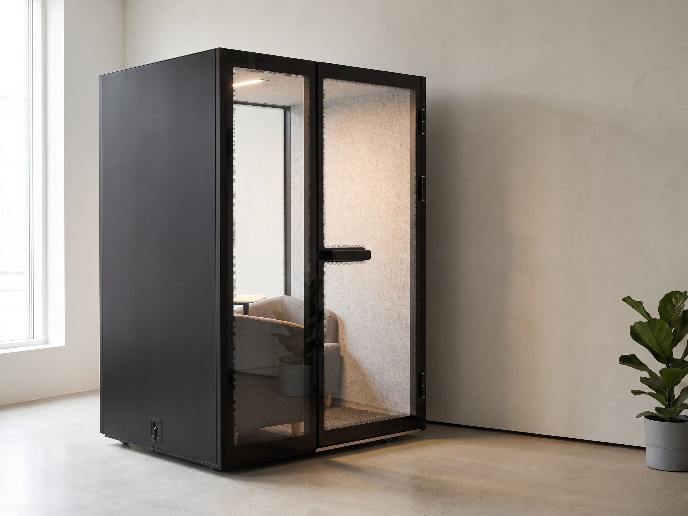 An M2-Pod standing against a plain pale wall in a quiet, uncluttered interior, lit by daylight from a window to one side