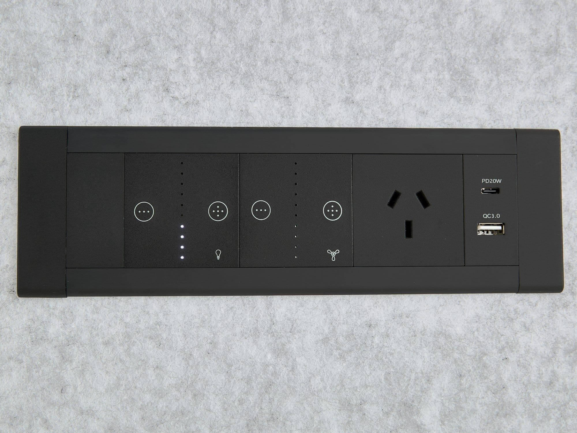 The Peacepod control panel — touch controls for lighting and ventilation alongside a mains socket, USB-A and USB-C, set into the grey acoustic felt wall