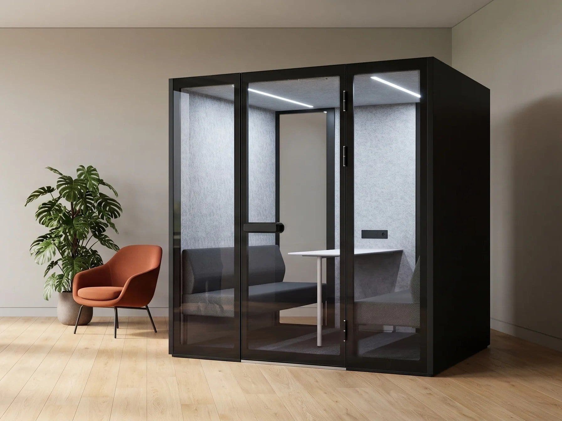 An XL-Pod in a bright office, alongside an orange lounge chair and a potted plant