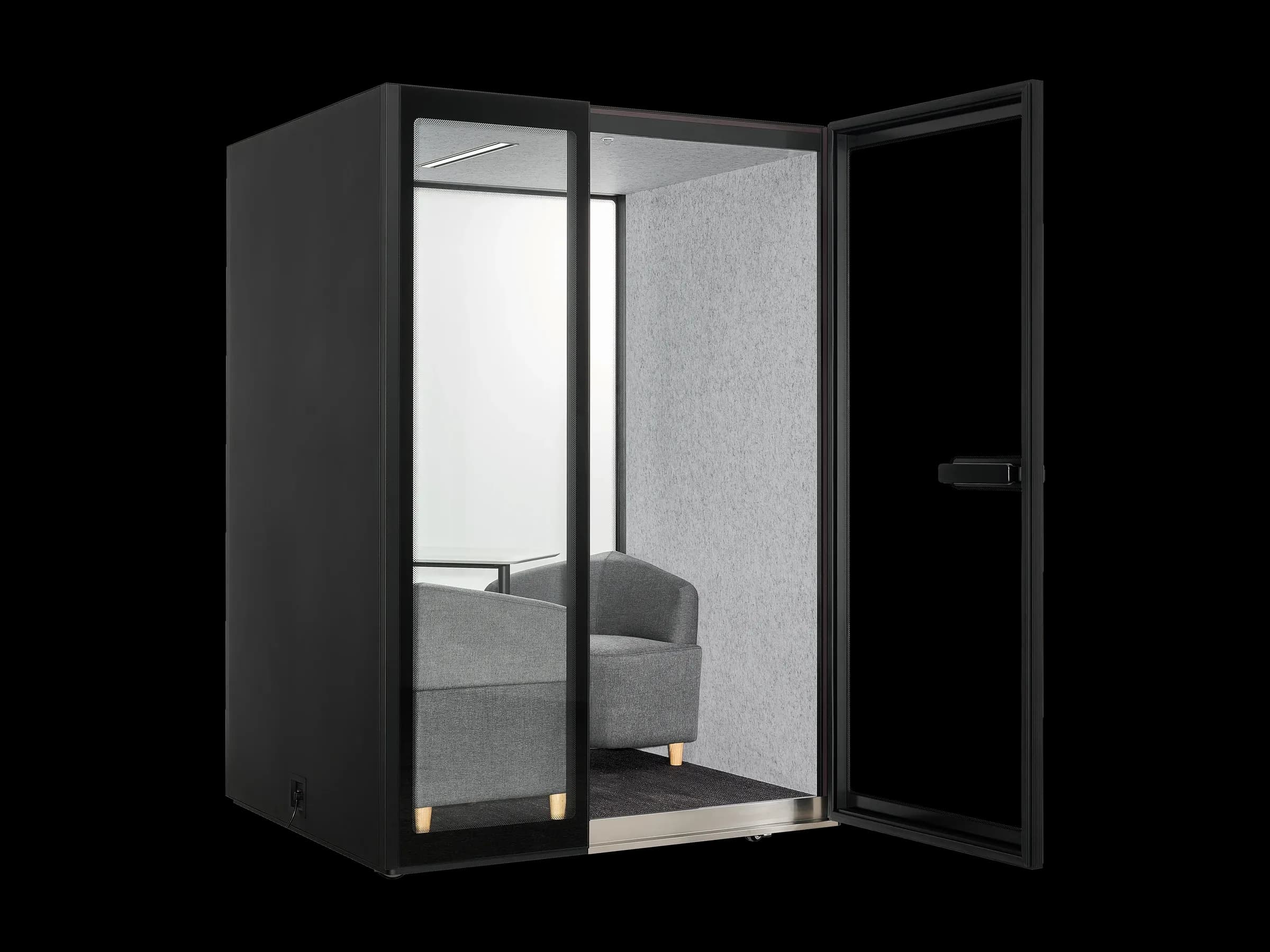 An M2-Pod with its door open, showing the upholstered sofa chairs and table inside